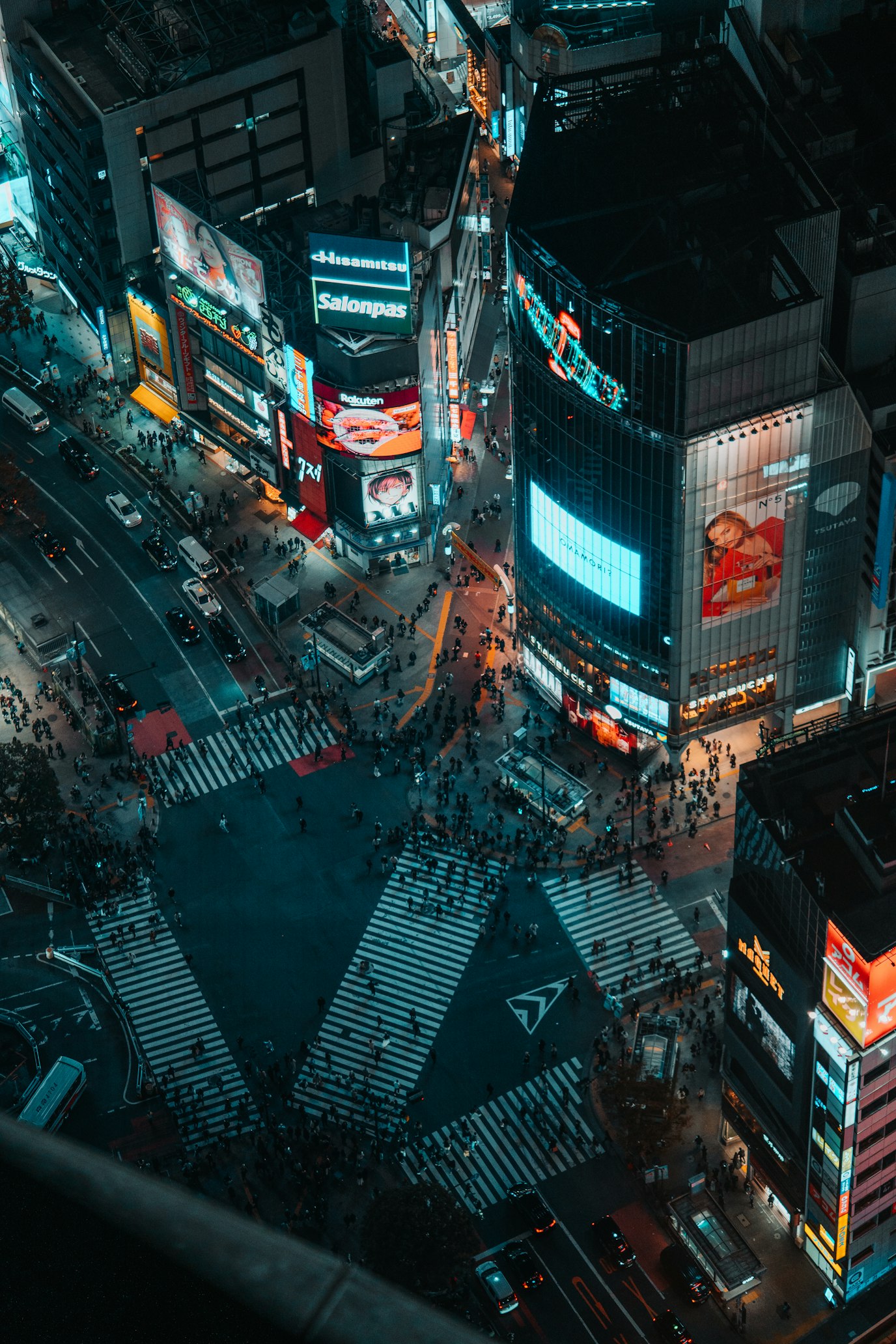 Busy Shibuya Crossing at night with neon lights