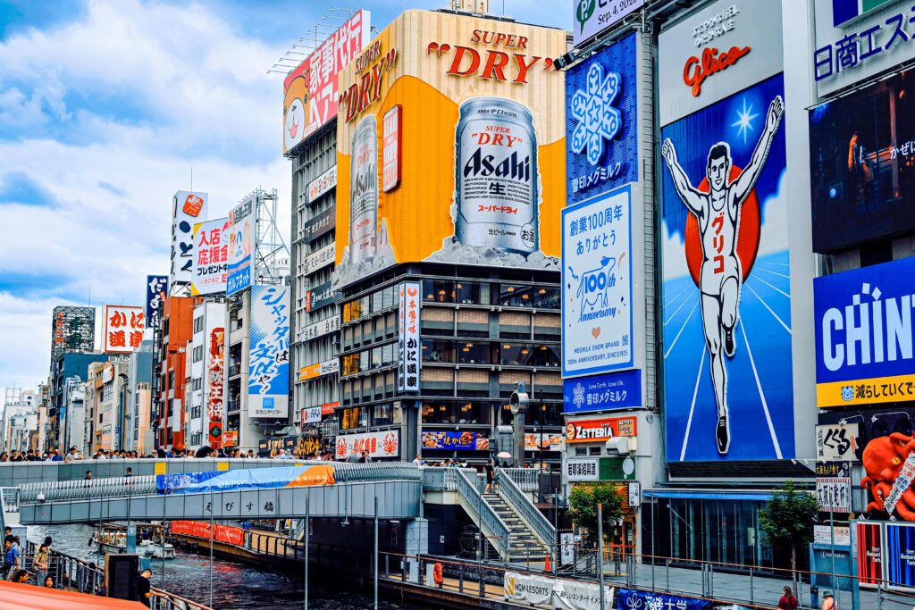 Colorful cityscape of Dotonbori's iconic signage along the canal in Osaka, Japan.